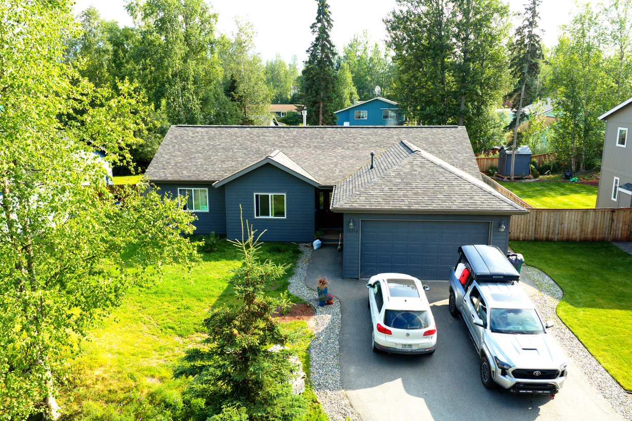 Low aerial drone photo showing the front approach of an Alaska home