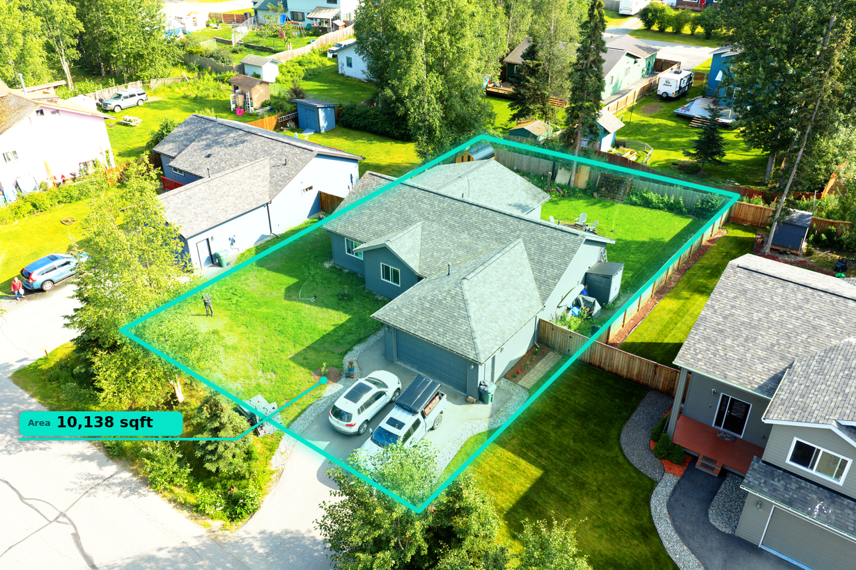 High aerial drone photo of the opposite corner approach of an Alaska home with property lines